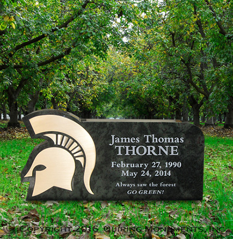 This custom shaped upright monument features a bronze inlayed Spartan helmet